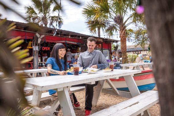 A couple eating at Cali N' Tito's outdoor seating in Athens, GA.