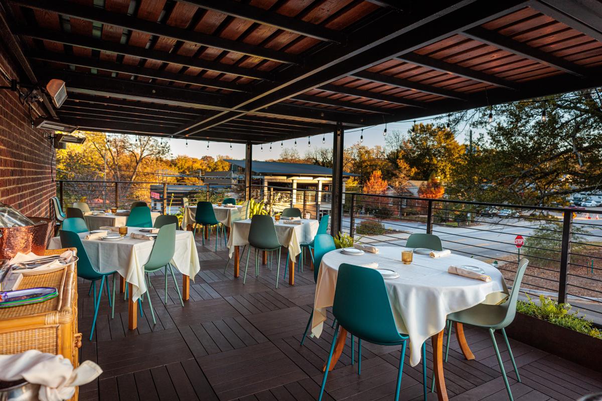 Several tables in an outdoor dining area.