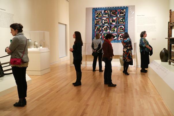 People viewing a quilt at the Georgia Museum of Art