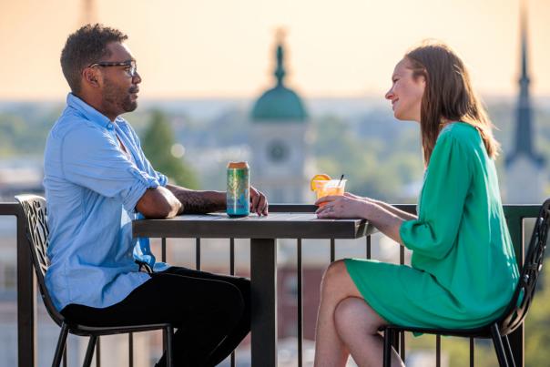 Couple with cocktails Hybar rooftop downtown Athens